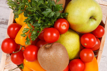 Fresh fruits and vegetables in wooden box. Food containing healthy minerals and vitamins