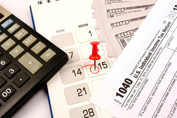 Red pushpin in calendar on 15th April for US tax day