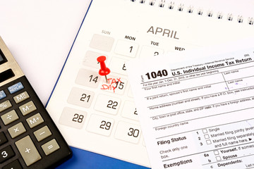Red pushpin in calendar on 15th April for US tax day