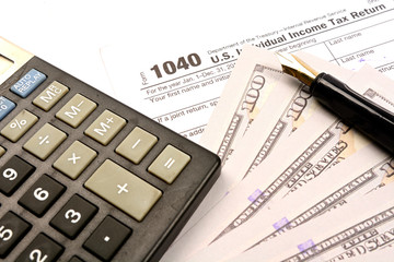 Calculating US tax with 1040 tax form on white background