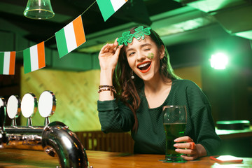 Long-haired young cute girl in a nice green blouse winking