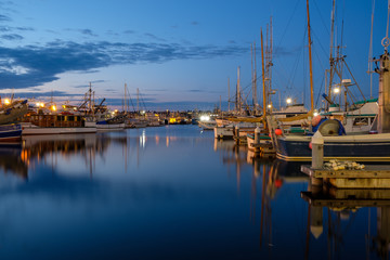 Fototapeta na wymiar Long exposure of boats at a harbor at nighttime