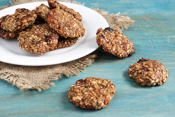 homemade oat cookies and ingredients on  blue wooden table soft focus
