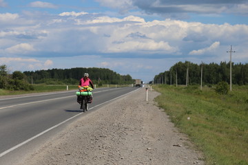 woman riding bicycle on country road