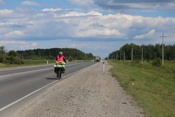 Obraz premium woman riding bicycle on country road