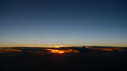 Photo of gorgeous tropical sunset taken from a plane window