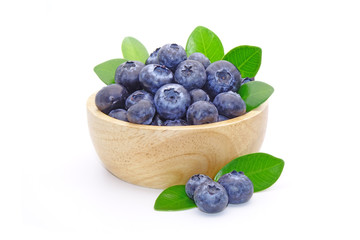 Blueberry : fresh blueberries with green leaves in wooden bowl isolated on white background.