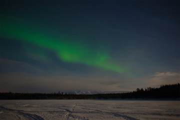 Aurora Borealis over the frozen Imandra Lake. Khibiny, Kola Peninsula. Russia