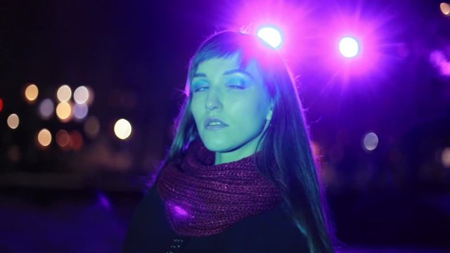 Fashion, model girl posing in neon light, shows her emotions.