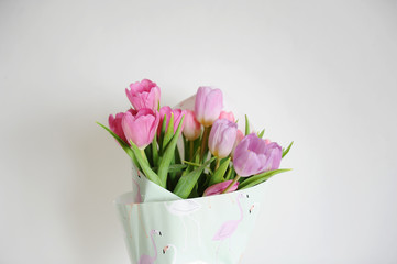 Delicate flowers tulips bouquet on a white background. Flamingo wrapping paper