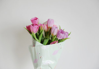 Delicate flowers tulips bouquet on a white background. Flamingo wrapping paper