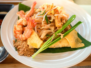 Rice noodles (Pad Thai) with shrimps and vegetables close-up on the table., traditional Thai dish with stir fried rice noodles.