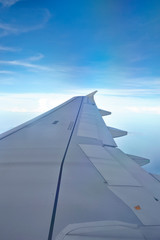 Fototapeta na wymiar Window view of plane on wingside