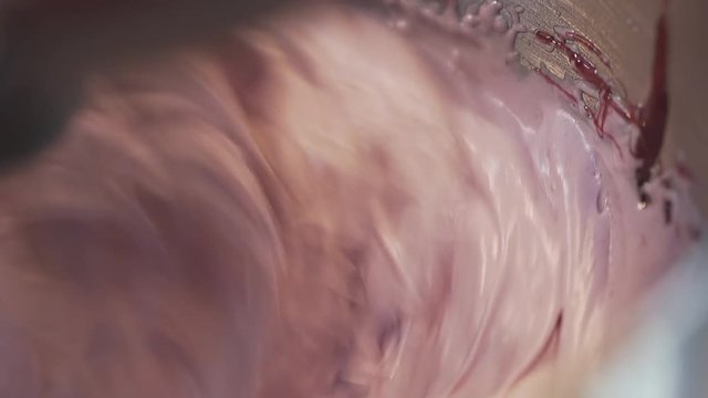 closeup electrical cooking mixer finishes preparing sweet dense air cake cream by high speed spinning