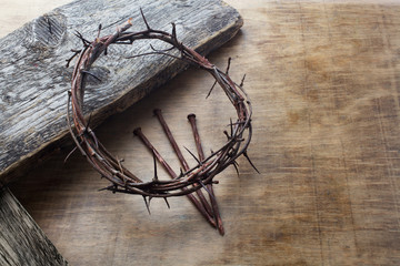 Jesus Crown Thorns and nails on Old and Grunge Wood Background. Vintage Retro Style.