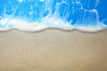 Fototapeta na wymiar Blue ocean wave on sandy beach. Top view