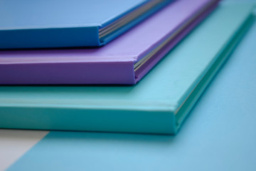 stack of multicolored books on a neutral background