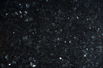 Natural stone of black color with bright sparkles with bluish tint, called labradorite Emerald Pearl