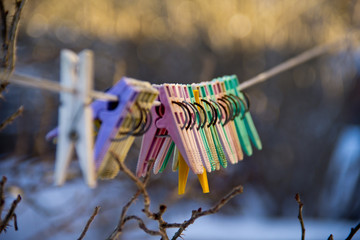 colorful clothespins on a rope in winter