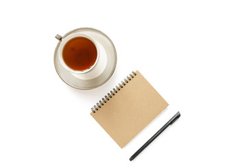 A cup of tea, notebook and pen