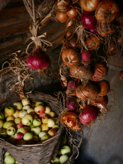 Red and green apples in a basket on a wooden background