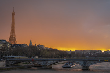 Fototapeta na wymiar Paris, France - 03 17 2019: Quays of the Seine. View of Eiffel Tower from Alexander III Bridge