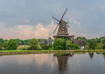 Naklejka premium The old windmill in a village against sky