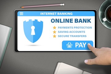 hand with tablet pc tapping button pay on modern table background - internet online banking technology concept