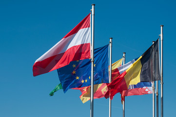 closeup of european flags on blue sky background