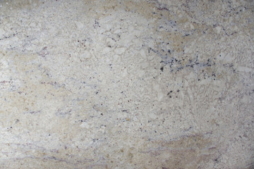Background natural light beige stone with dark speckles called granite Bianco Romano