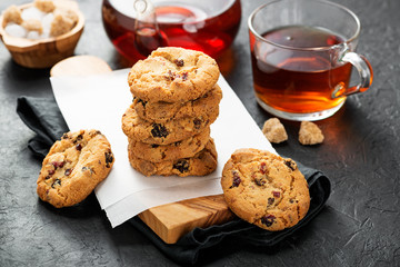 Cranberry cookies served with tea cup on wooden table. 