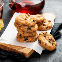 Cranberry cookies served with tea cup on wooden table. 