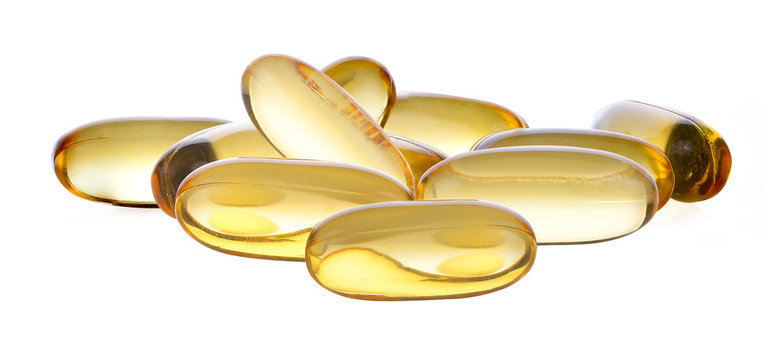 Close up of food supplement oil filled capsules suitable for: fish oil; omega 3; omega 6; omega 9; evening primrose; borage oil; flax seeds oil; vitamin A; vitamin D; vitamin D3; vitamin E