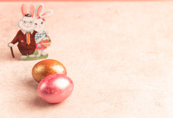 Easter eggs, pink and orange colour, Easter bunnies on background