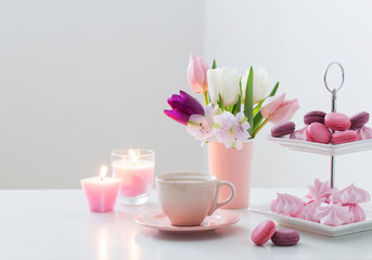  Tulips in vase and cup of coffee with dessert on white backgrou