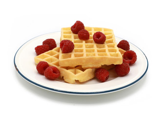 fresh belgian waffles with raspberrys on a plate isolated on white background