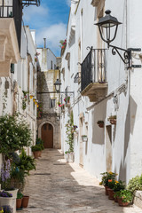 Walking in Locorotondo. Narrow streets and white houses. Dreamlike Puglia, Italy