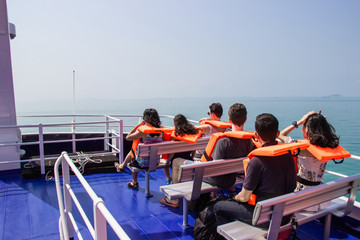 Male and female tourists take a ferry ride for travel relax at Koh Kood island, Trat province.