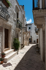 Fototapeta na wymiar Walking in Locorotondo. Narrow streets and white houses. Dreamlike Puglia, Italy