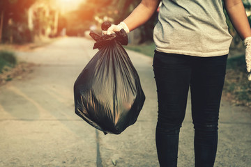 woman hand holding garbage bag for recycle cleaning