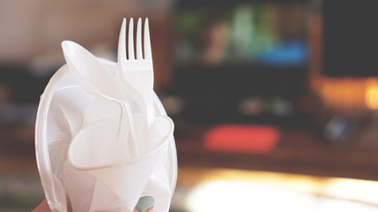 Hands break plastic dishes, people ban and stop using plastics garbage. Concept of Recycling...