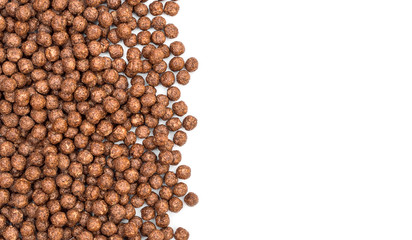 Chocolate cereal balls on white. Space for text. Top view.