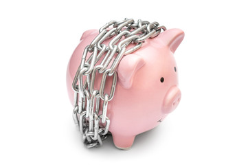 Piggy bank wrapped by chain on white.