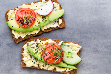 Sandwiches with cream cheese, vegetables and salami.