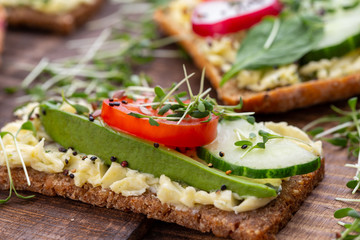 Sandwiches with cream cheese, vegetables and salami.