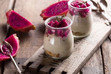 Yogurt with Ripe Dragon fruit, Pitaya or Pitahaya on wooden background, fruit healthy concept