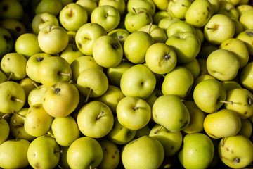 Fresh organic green apples on the farmers market. Food apple background.
