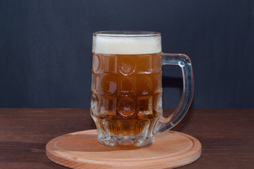mug of beer on dark background