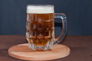 mug of beer on dark background