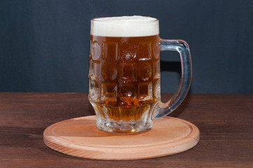 mug of beer on dark background